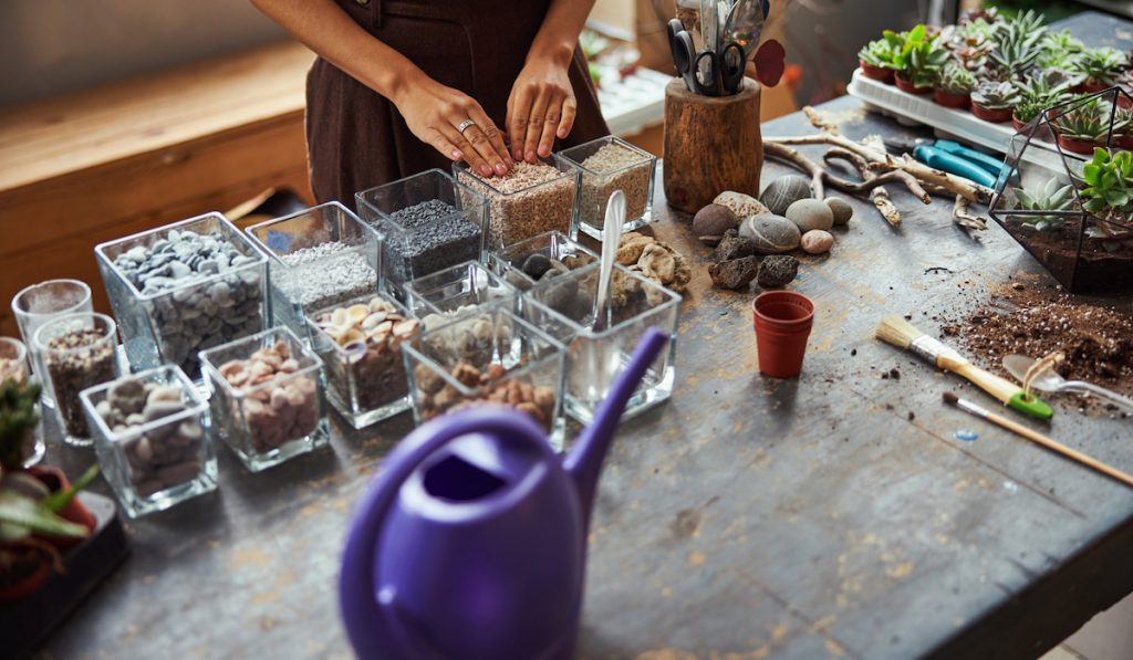 florist choosing pebbles to use for a project