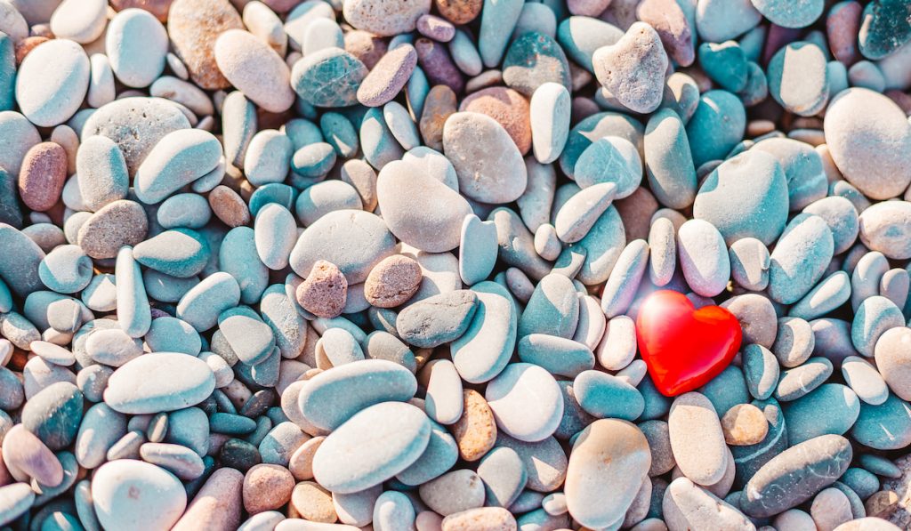 red heart on pebbles