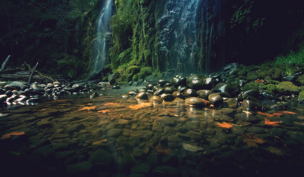 rocks near waterfall on river